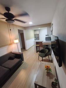 a living room with a couch and a ceiling fan at Quiet place in El Seis