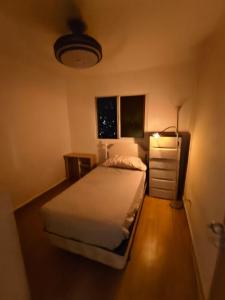 a small bedroom with a bed and a dresser at Quiet place in El Seis