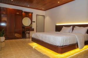 a bedroom with a large bed and a table at Lullaby Marine Villa in Wadduwa