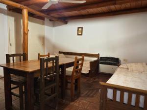a dining room with a table and chairs and a bed at Finistterra in Tanti +41 photos