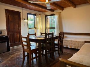 a dining room with a table and chairs and a bed at Finistterra in Tanti