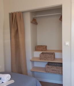 a bedroom with a closet with baskets and shelves at Dalgaci Deniz Konukevi in Ayvalık +36 photos