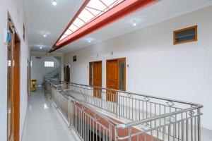 a walkway in a building with a skylight at RedDoorz at Syariah House Purwokerto in Purwokerto +45 photos