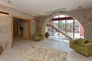 a living room with an archway in a building at Casas do Bacelar by Liiiving in Quinchães