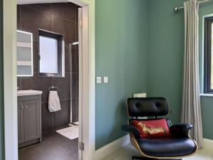 a bathroom with a black chair and a shower at Property 525 - Galway in Moycullen +27 photos