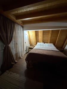 a bedroom with a bed in a wooden room at Etno selo Vukovic Bijelo Polje in Bijelo Polje +42 photos