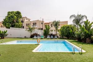 a swimming pool in the yard of a house at Oroklini Hills Modern Sea View Apartments in Oroklini