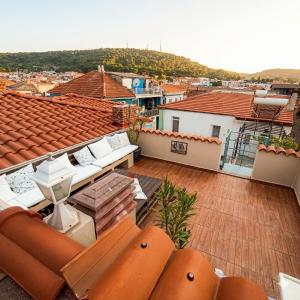 a balcony of a house with orange roofs at Dalgaci Deniz Konukevi in Ayvalık