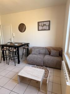 a living room with a couch and a table at Le COCON centre de Bethune in Béthune +9 photos