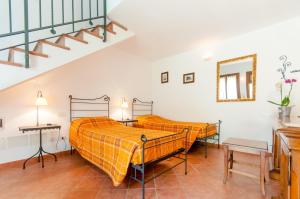 two beds in a room with a staircase at Il Giardinetto Rooms in Ferrara