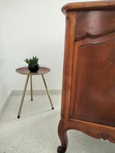 a bed and a table with a potted plant on it at La Dormeuse in Vignacastrisi +3 photos