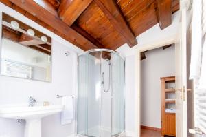 a bathroom with a glass shower and a sink at Il Giardinetto Rooms in Ferrara +9 photos