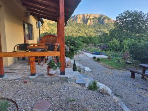a porch of a house with a table and a bench at Ramonda Serbica - Gorge View & Peacful Nature Retreat in Niš +84 photos