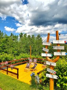 a sign with chairs and tables on a deck at Czarna Owca in Istebna