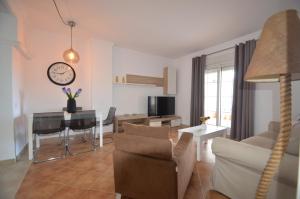 a living room with a table and a dining room at La Marina Solmares in Isla del Moral
