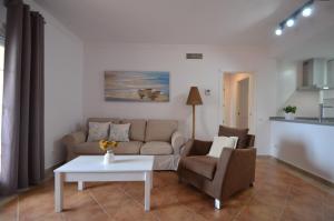 a living room with a couch and a table at La Marina Solmares in Isla del Moral