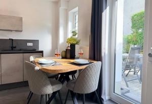 a dining room table with chairs and wine glasses at Haus Übernachtenswert Cochem Mosel in Cochem