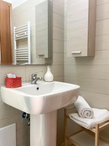 a bathroom with a white sink and a mirror at La Piazzetta in Torella deʼ Lombardi