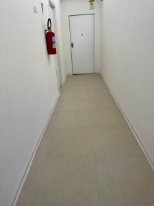 a hallway with a tile floor and a fire extinguisher at Marechiaro apartment in Monopoli +1 photo