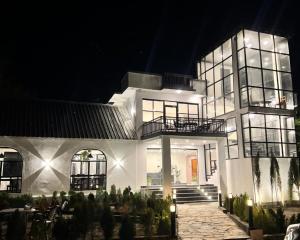 a large white house at night with lights at Hotel Desert Bloom Skardu in Skardu +14 photos