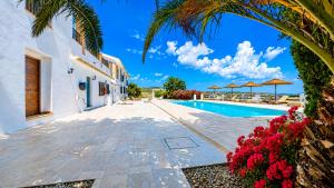 a villa with a swimming pool and a palm tree at Lemon Tree Retreat at El Amparo in Alhama de Granada