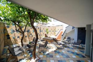 a patio with chairs and a table and trees at SEASIDE TWINS b&b in Fragagnano