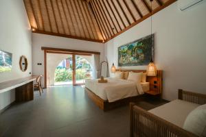 a bedroom with a bed and a desk in a room at Casa Nova Villa Uluwatu in Uluwatu +52 photos