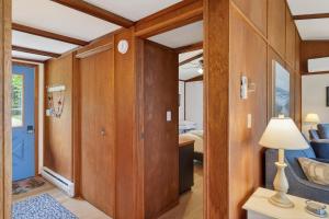 a room with wooden walls and a door with a lamp at Egg Harbor Waterfront home in Egg Harbor