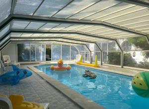 a large swimming pool with animals in the water at Hotel De La Mer in La Tranche-sur-Mer