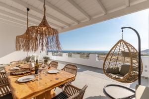 a dining room with a table and chairs at Naxian Pearl in Mikri Vigla