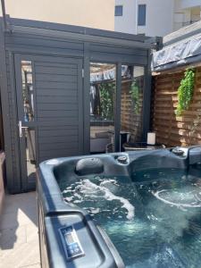 a jacuzzi tub in front of a house at Cabane insolite avec jacuzzi in Menton