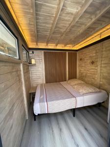 a bed in the middle of a room at Cabane insolite avec jacuzzi in Menton