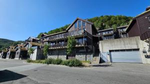 a group of houses with a parking lot at Beautiful apartment in Sinnes E12 in Dirdal