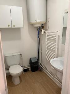 a bathroom with a toilet and a sink at Studio à Bussy St Georges in Bussy-Saint-Georges