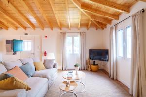 a living room with a couch and a table at Casa Amarela do Redondo in Seixal