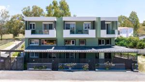a house with green and white at EREA Homes Apartments in Eretria