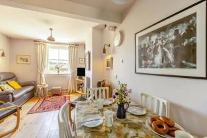 a living room with a dining room table and a couch at 3 Bed in Bridport oc-dc160 in Bridport