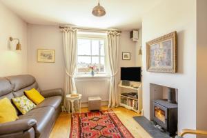 a living room with a couch and a fireplace at 3 Bed in Bridport oc-dc160 in Bridport