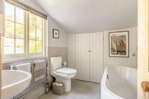 a bathroom with a tub and a toilet and a sink at 3 Bed in Bridport oc-dc160 in Bridport +32 photos