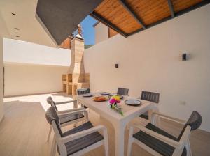 a dining room with a table and four chairs at Villa Ocak 1 in Kaş