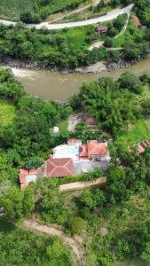 an aerial view of a house next to a river at Hotel para descanso con piscina in San Gil +2 photos