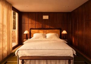 a bedroom with a large bed with wooden walls at Bourbon Hôtel in Courchevel
