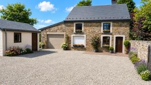 a stone house with two garage at Maison Samree met Indoor Wellness in La-Roche-en-Ardenne