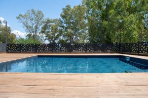 a swimming pool with a black fence around it at EREA Homes Apartments in Eretria