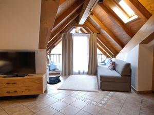 a living room with a couch and a television at Hotel Thaler in Rietz