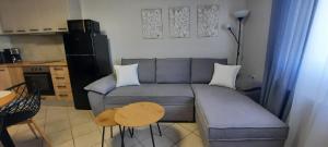 a small living room with a couch and a table at Olena Apartment in Nea Moudania