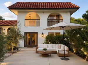 a house with a white couch and an umbrella at Lavender House and Guest House in Ojai
