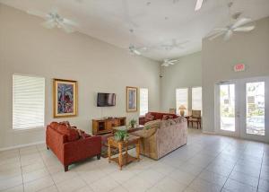 a living room with two couches and a tv at Coral Hammock Poolside Home in Key West