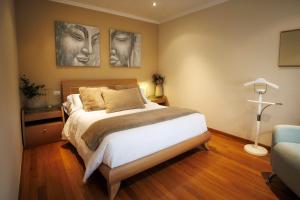 a bedroom with a bed with two pictures on the wall at Casa dos olivos in Ourense +27 photos