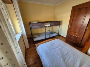 a small room with a bed and a staircase at Toca dos Coelhos in Silveira